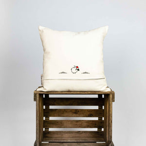 Fluffikon silk square pillow made from golden moroccan fabric. The pillow is on a wooden box shown from the back.