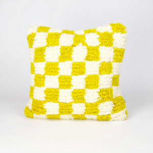 Beni Ourain Fluffikon pillow with yellow white checkered pattern. The pillow is made from wool. It stands in front of a white background.