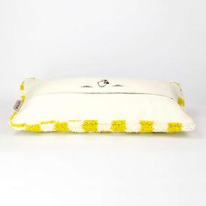 Side view of a Beni Ourain Fluffikon lumbar pillow with yellow white checkered pattern made from a wool carpet.
