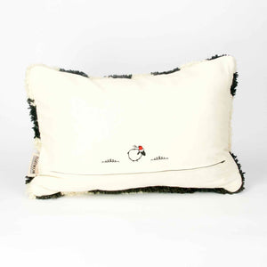 The back of a black and white Fluffikon rug pillow.