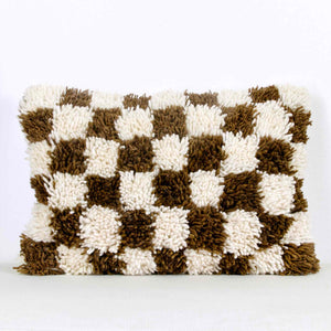 Brown checkered Fluffikon throw pillow. The Moroccan pillow was made from a Berber Beni Ourain wool rug.