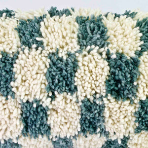 Zoom on the wool of a checkered Moroccan Lumbar Pillow