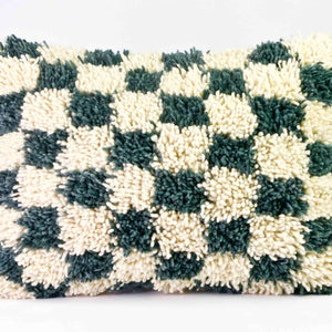 Checkered Moroccan Throw Pillow. The pillow is made of a checkered wool rug.