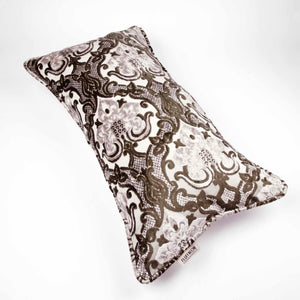 Large couch pillow made from brown beige velvet fabric. The pillow is in front of a white background.