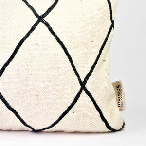 Zoom the corner of a black and white Fluffikon Kilim throw pillow.