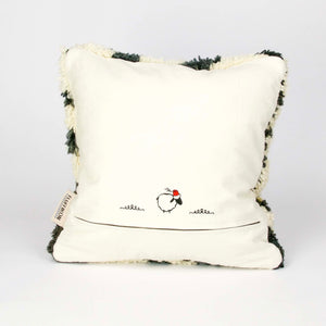 Back view on a vintage rug pillow made from a Moroccan carpet standing.