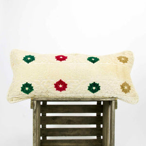 Grosses marokkanisches Fluffikon Kissen aus Samt. Das Kissen steht auf einer Holzbox.