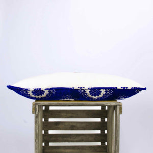 Piped edges of blue velvet couch pillow.