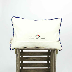 The back of blue velvet pillow on a wooden box.