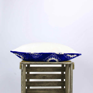 Side view of blue velvet pillow with Moroccan tile motif.