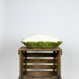 Fluffikon grey green decorative pillow with flowers made from moroccan velvet fabric. The throw pillow is shown from the side.