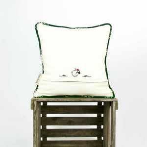 Back of green velvet throw pillow with piped edges