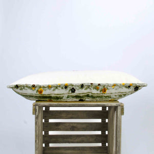 Side view of a grey velvet sofa pillow