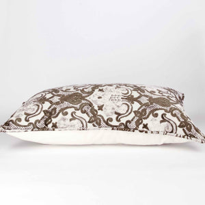 Large couch pillow with brown beige velvet. The pillow is lying on the ground.