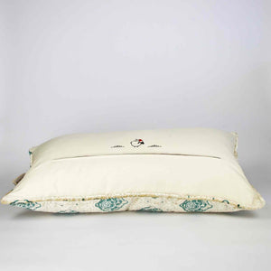 Oversize Fluffikon throw pillow in front of white background. The pillow is shown from the back laying on the ground.