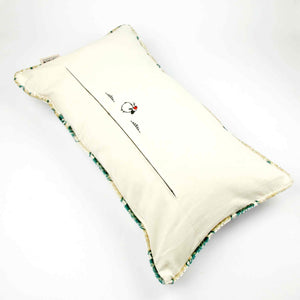 Oversize Fluffikon throw pillow shown from the back. The pillow has piped edges.