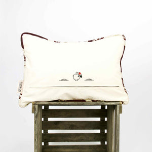 Burgundy Red velvet decorative pillow on wooden box.