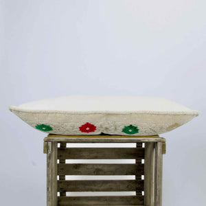 Side view of a large Moroccan velvet pillow. The pillow has a traditional moroccan design.