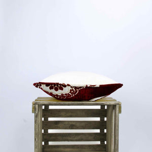 Royal velvet pillow lying on a wooden box.