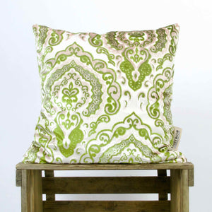 Green Beige Sofa Pillow on a wooden box.