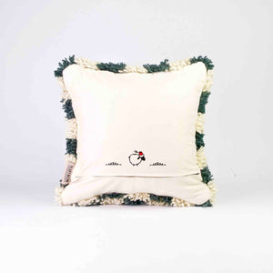 Back view of a checkered Moroccan Fluffikon pillow standing in front of a white background.