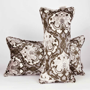 Two large couch pillows made from brown beige velvet fabric. The pillows have an oriental / moroccan look.