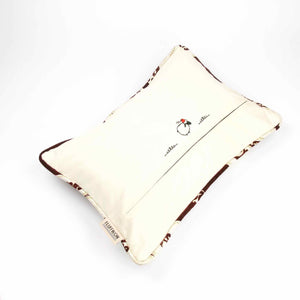 Velvet decorative pillow with piped edges.