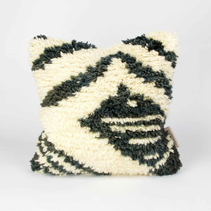 Vintage rug pillow made from a Moroccan carpet standing.