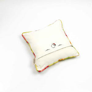 Back of yellow square Brocade pillow on the ground.