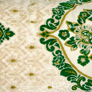 Zoom on a large pillow with oriental look. The pillow has traditional green moroccan pattern on a beige canvas background.