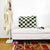 Checkered Moroccan Fluffikon throw pillow standing on a white bench. A red carpet is in front of the bench. The Berber pillow size is 40x60 cm.