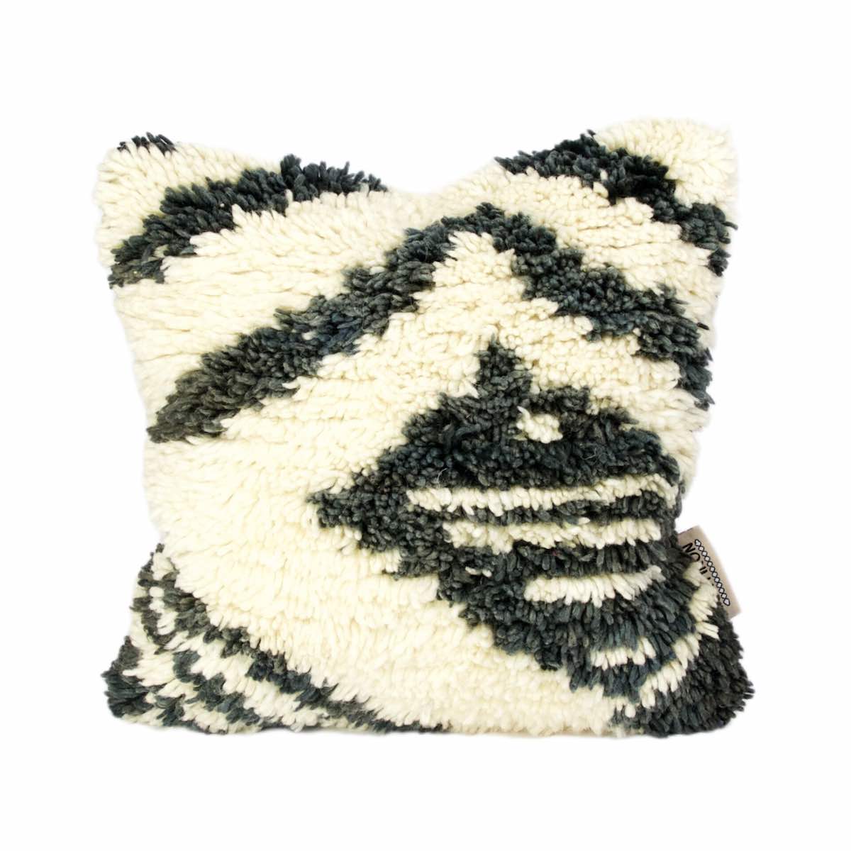 Fluffikon rug pillow made from black and white Moroccan wool rug. Its is presented as quirky new home gift idea.