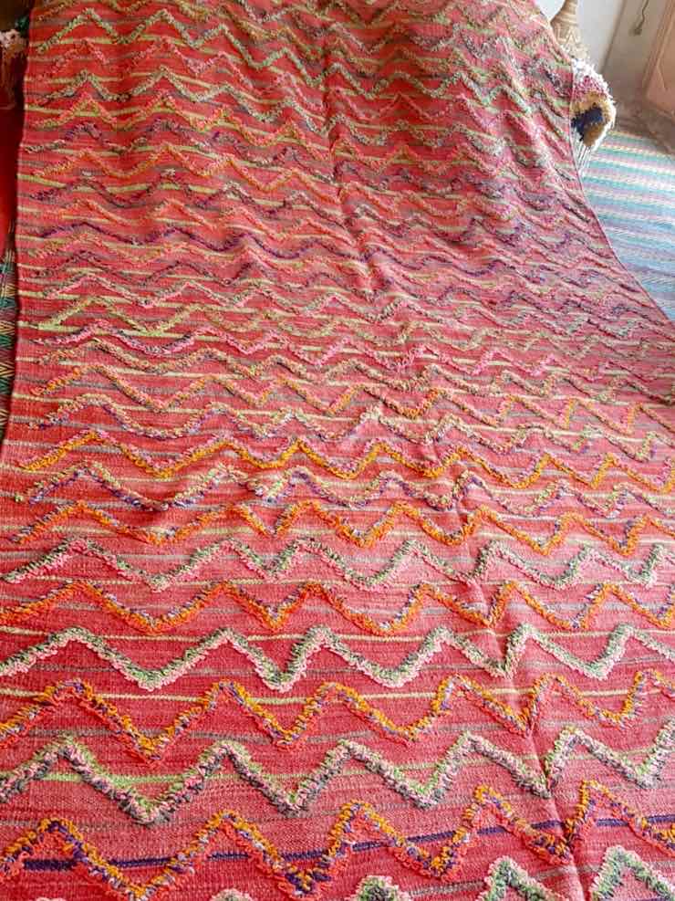 Red vintage Kilim rug that used for our customized Fluffikon wool dog beds / cats beds.