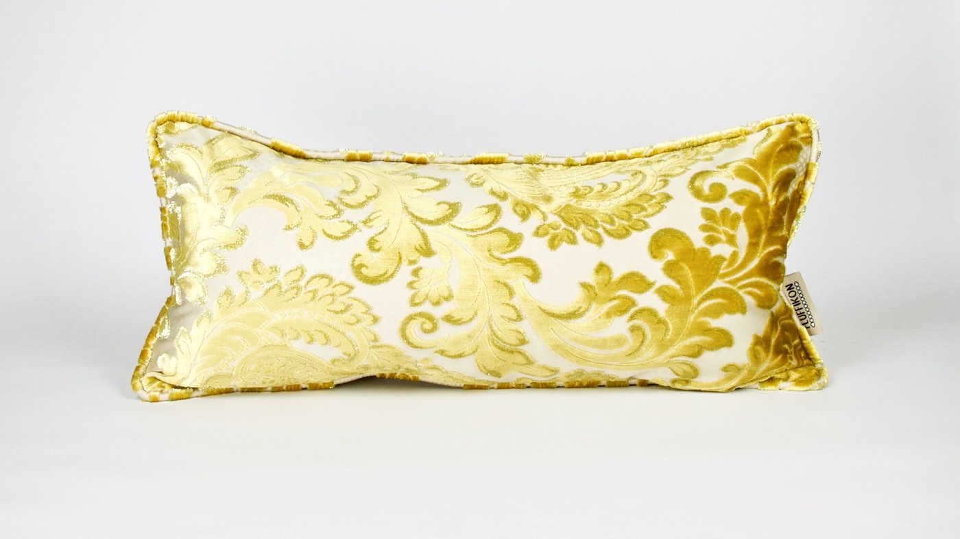A golden velvet lumbar pillow. The Fluffikon pillow is made from traditional Moroccan fabrics.