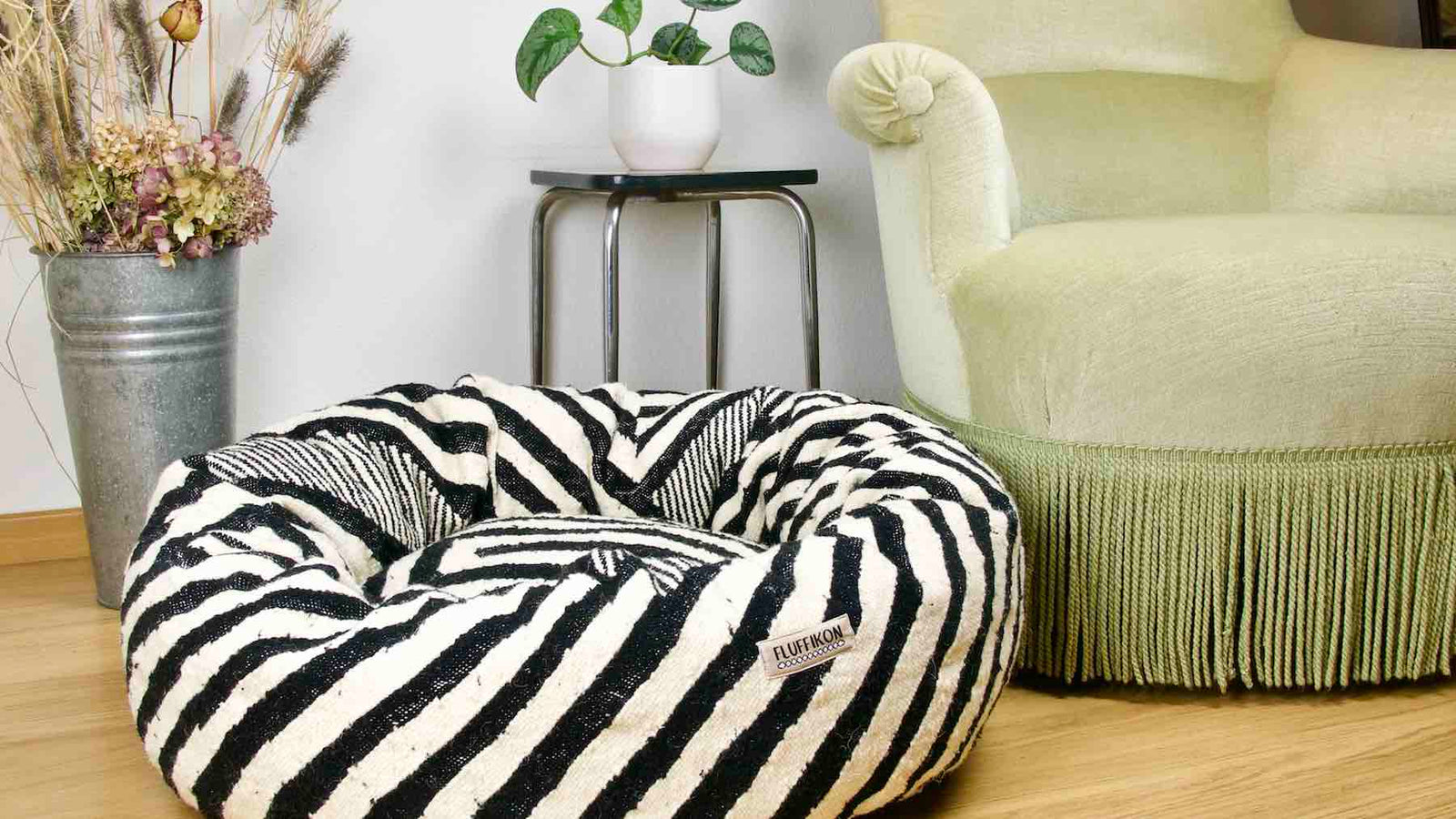 Black and white Kilim cat bed in a living room. The Bed is made from a Moroccan Kelim rug.