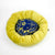 Blue golden Fluffikon dog bed in front of white background. The wool-filled dog is made from velvet fabrics.