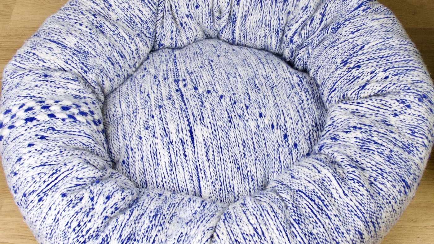 Blue and white Kilim dog bed that is made from a Moroccan rug. 