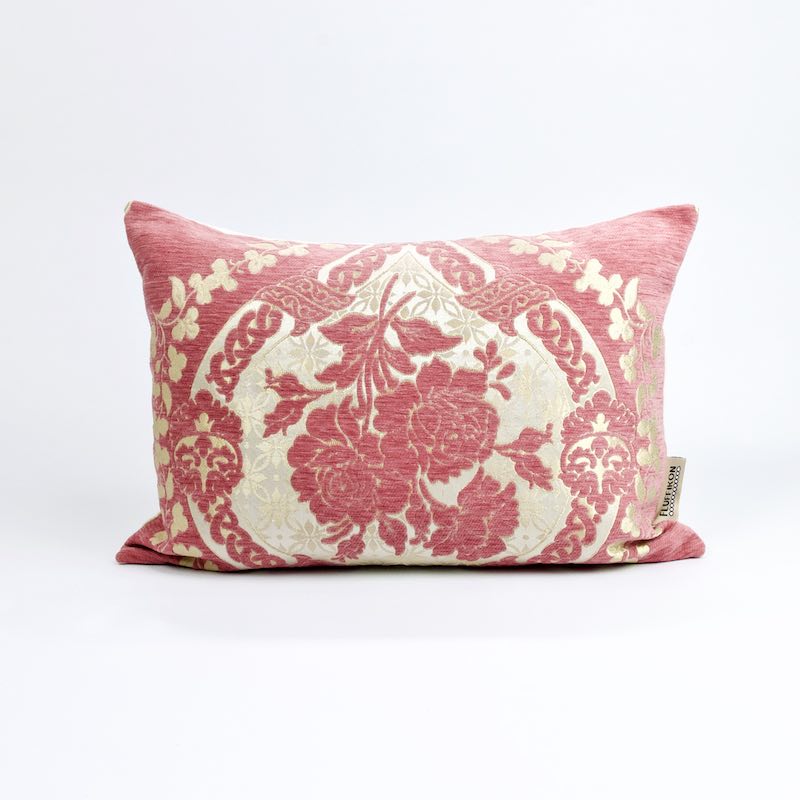 Blush pink decorative Fluffikon pillow. The pillow has a traditional Moroccan pattern made from golden flowers.
