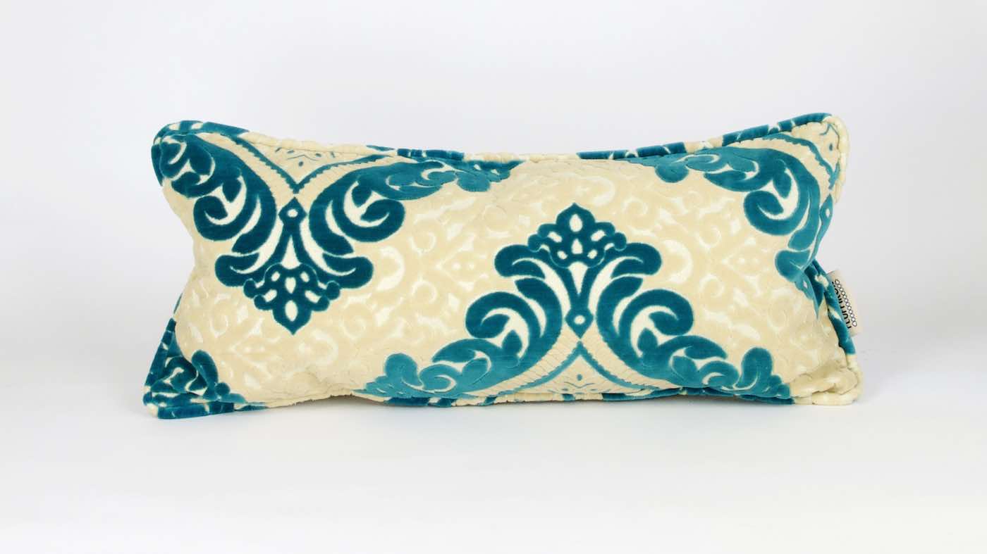 Moroccan lumbar cushion with traditional piped edges. The fabrics are used in traditional Moroccan living rooms.