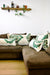 Four large Fluffikon throw pillows on a brown couch. The pillows have traditional Moroccan patterns.