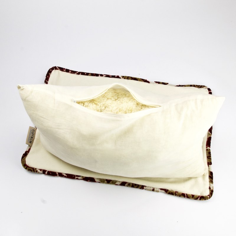 Top view on a Fluffikon rectangular velvet sofa pillow that shows the inside wool filling.