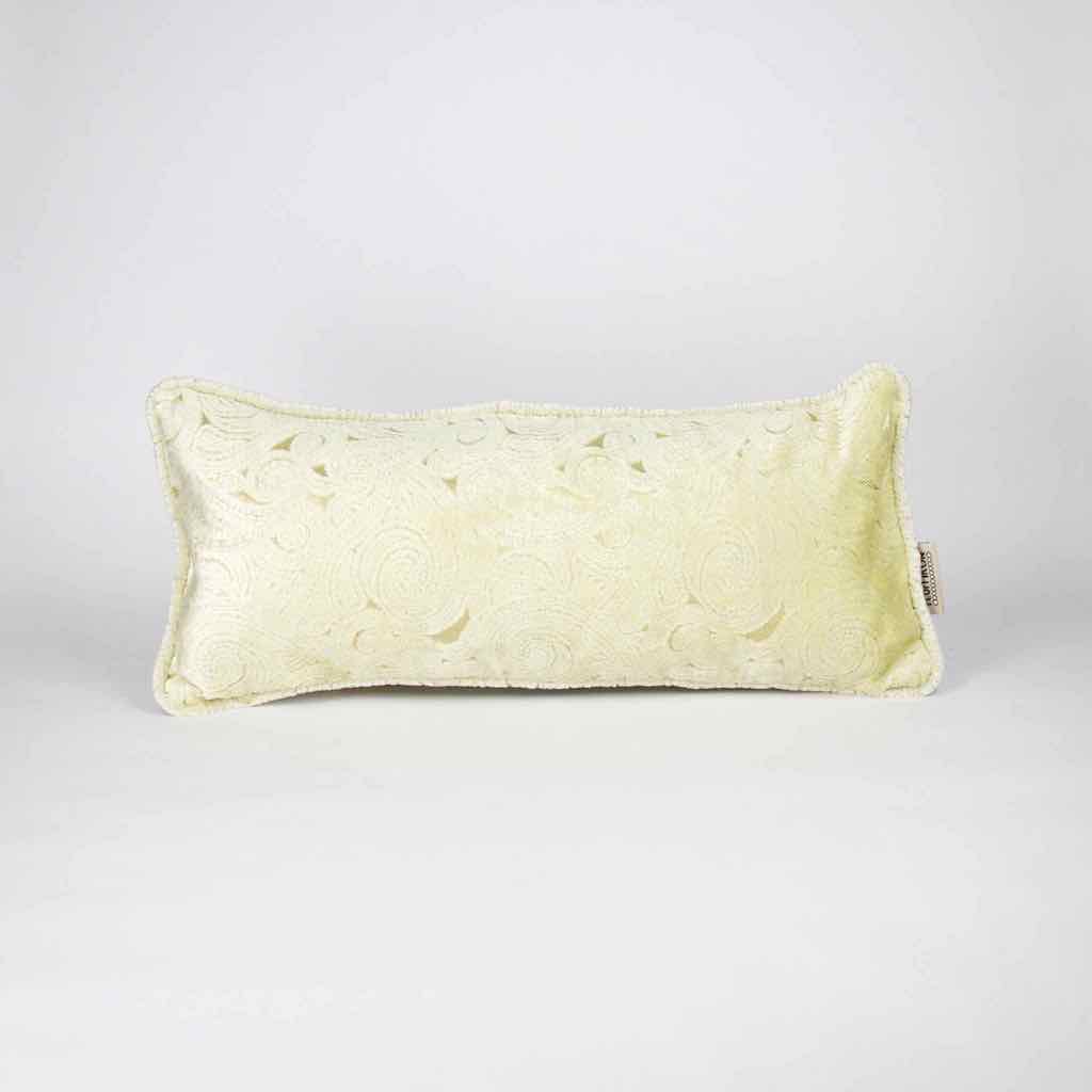 Beige Fluffikon lumbar decorative pillow standing in front of white background.