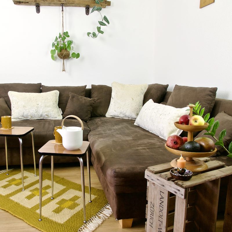 Three beige/gold Fluffikon velvet pillows in a living room. 