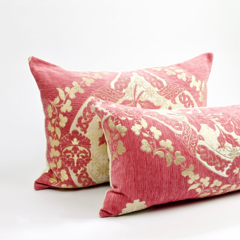 Two blush pink Fluffikon decorative pillows with golden flower motif. The pillows have a traditional Moroccan look.