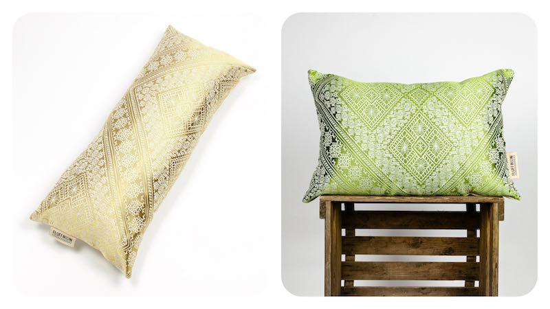One golden silk decorative pillow and one green silk decorative pillow.