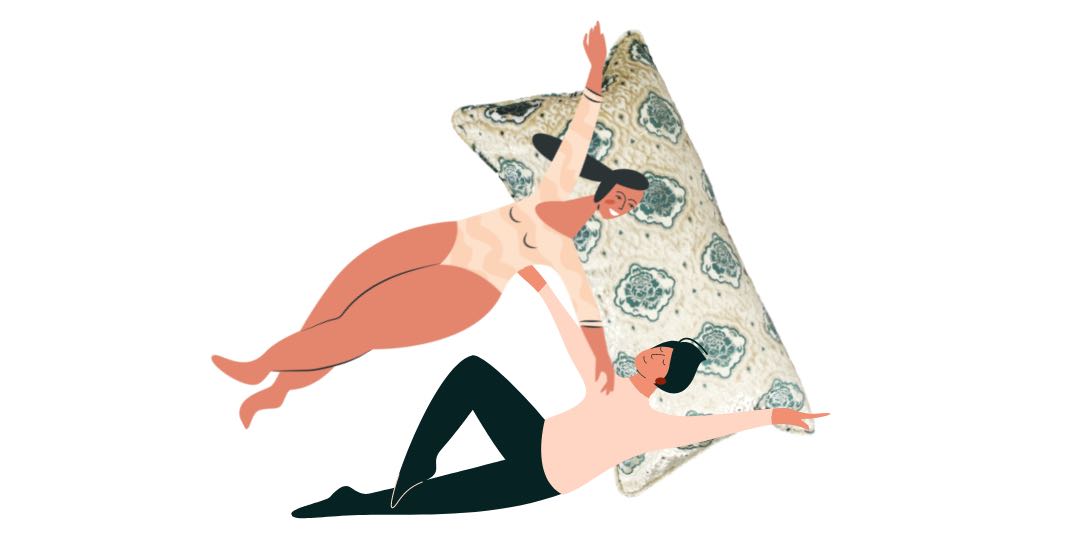 Two people laying on a large Fluffikon throw pillow. The XXL throw pillows has a Moroccan design.