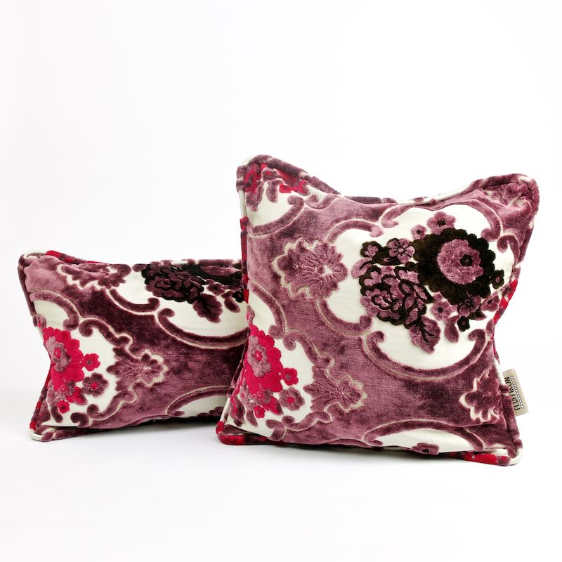 Two purple velvet throw pillows with floral motifs. The pillows have a typical Moroccan design.