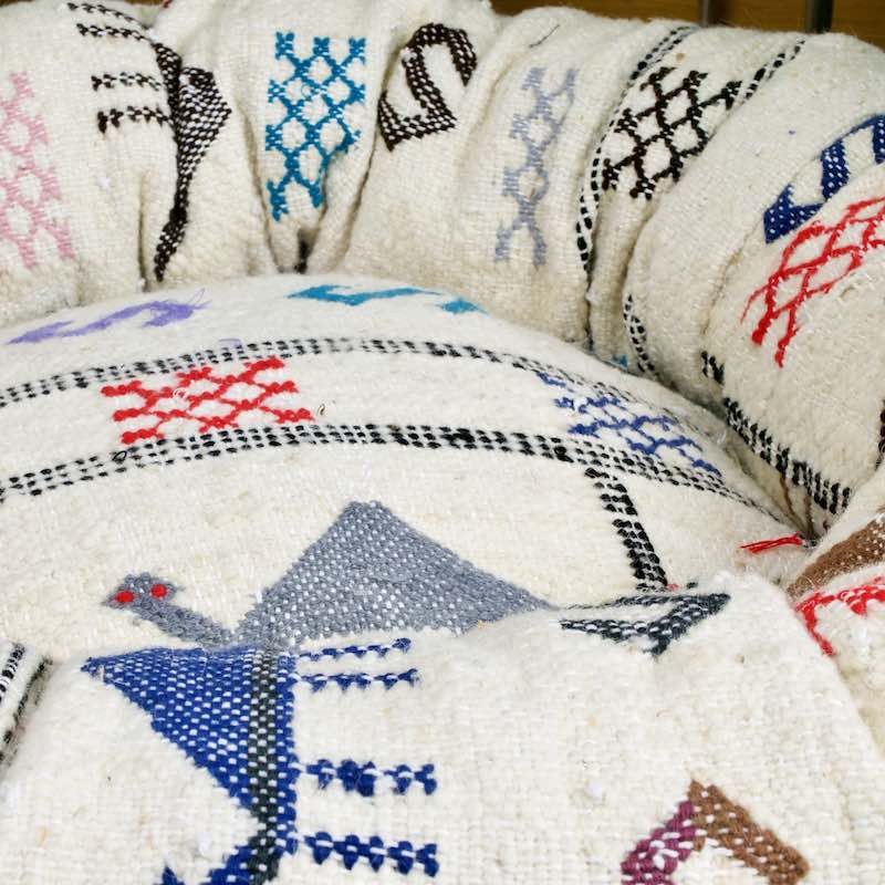 Zoom on a customized Fluffikon wool dog bed that is made from a Moroccan wool Kilim rug.