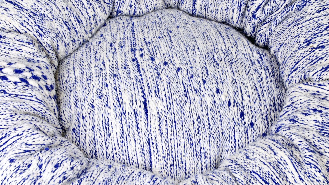 Zoom on blue and white Fluffikon Kilim dog bed that is made from a Moroccan wool rug.