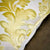 Zoom on golden Fluffikon pillow with a traditional moroccan pattern.